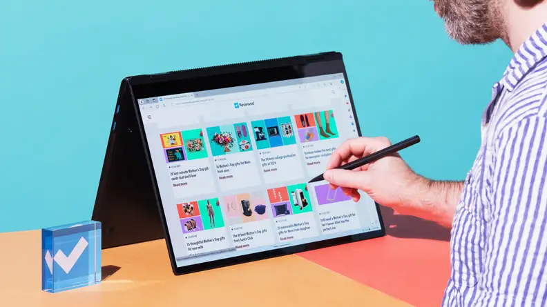 A person using the LG Gram Pro 16's touch screen in tablet mode.