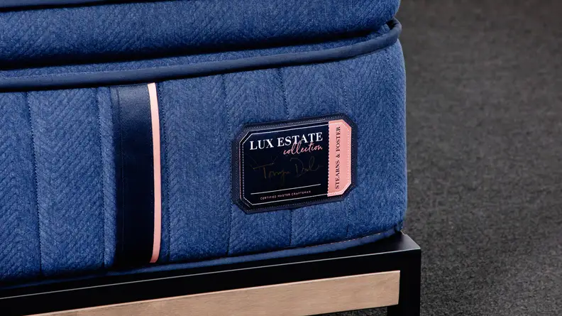 The brand badge on the edge of a mattress.