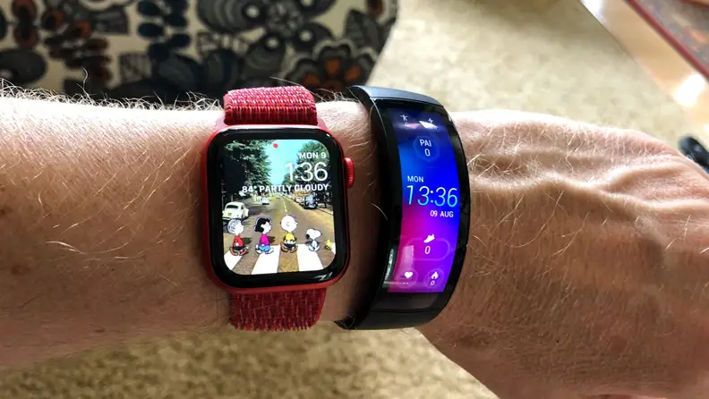 The all-black Amazfit X is shown next to an Apple Watch on a wrist with vivid color across its curved OLED display.