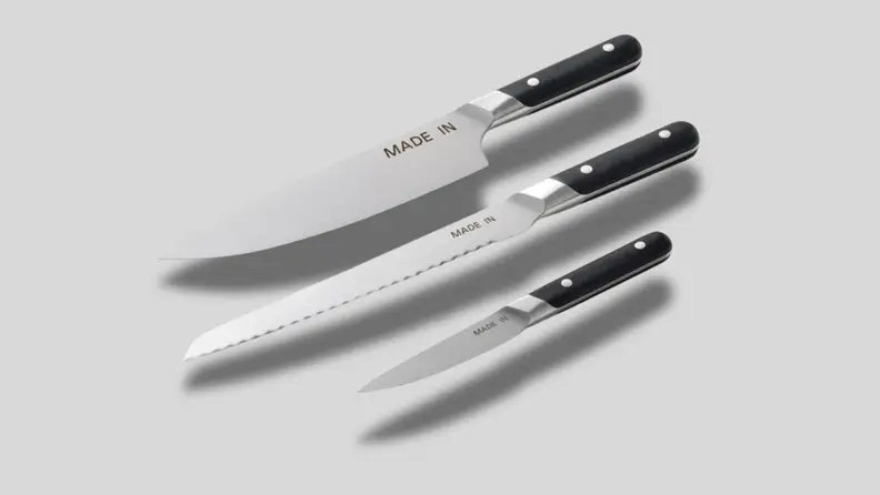 Three knives on a gray background