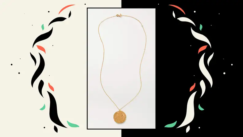 A gold necklace with a lion pendant.