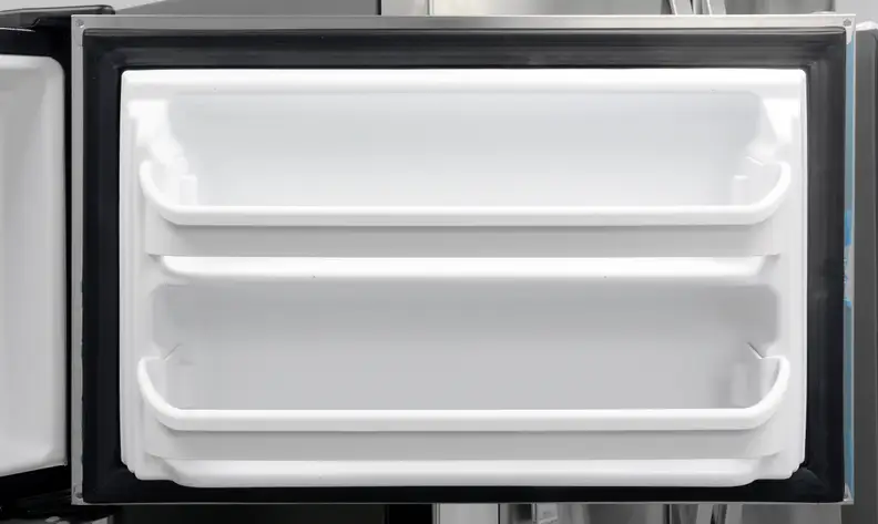 You'll notice some blue plastic around the door edges. That's leftover from the blue plastic coating meant to protect the Frigidaire FFTR1821QS's stainless finish in transit—and it's a nightmare to get off.