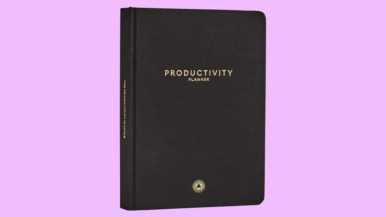 A black journal on a purple background.