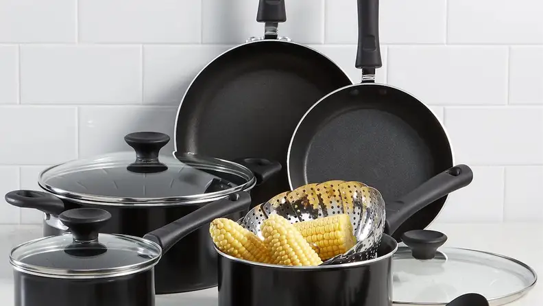 Black and silver Tools of the Trade cookware set sitting on the countertop.