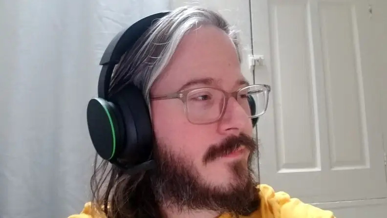 Man wearing Xbox Wireless Headset, looking to the side