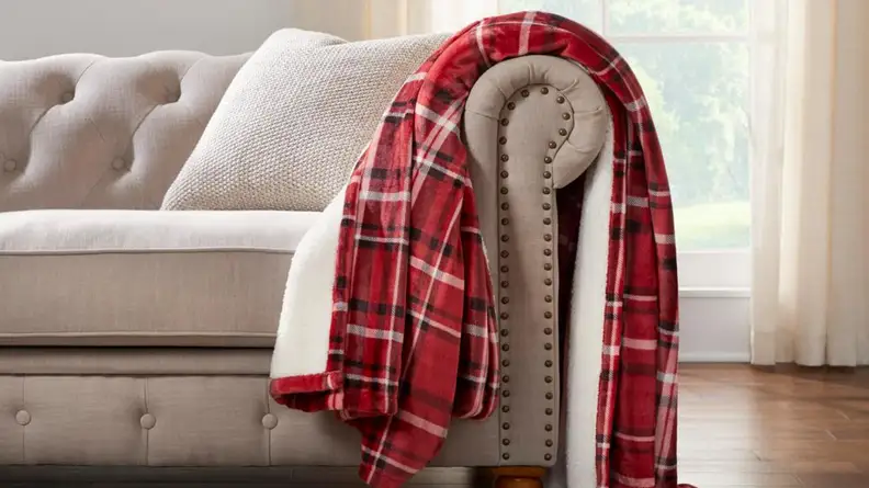 Red sherpa throw on a couch