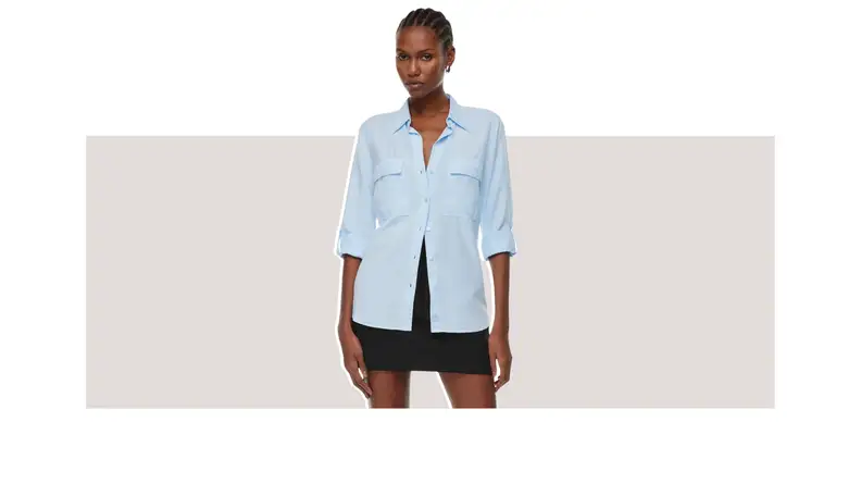 A model wearing a blue button-up dress shirt.