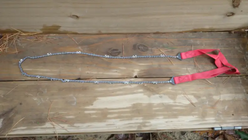 Pocket chainsaw on wooden surface.
