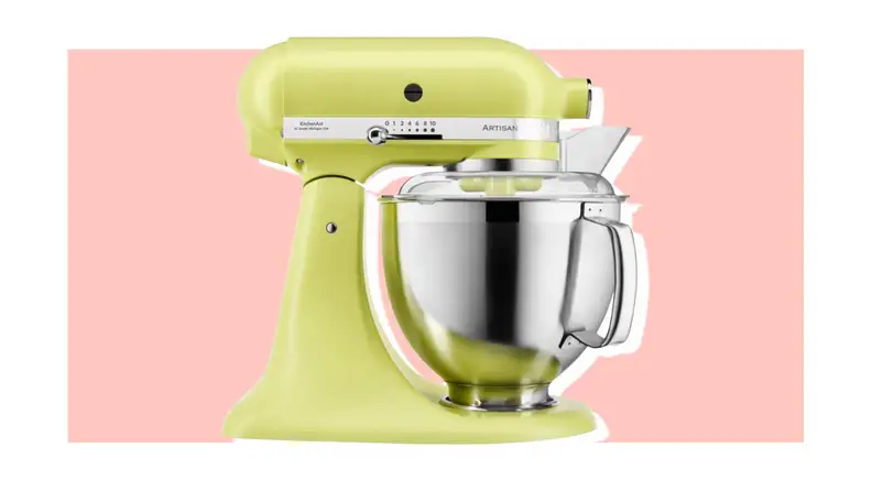 Green KitchenAid stand mixer on pink background