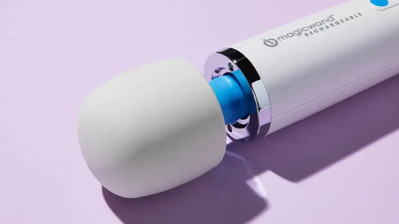 Close photo of the Magic Wand Rechargeable's head. The vibrator is sitting on a lilac-colored surface