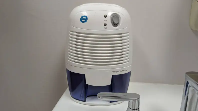 The Eva-Dry EDV-1100 small dehumidifier placed on a bathroom sink to reduce humidity in a small bathroom.