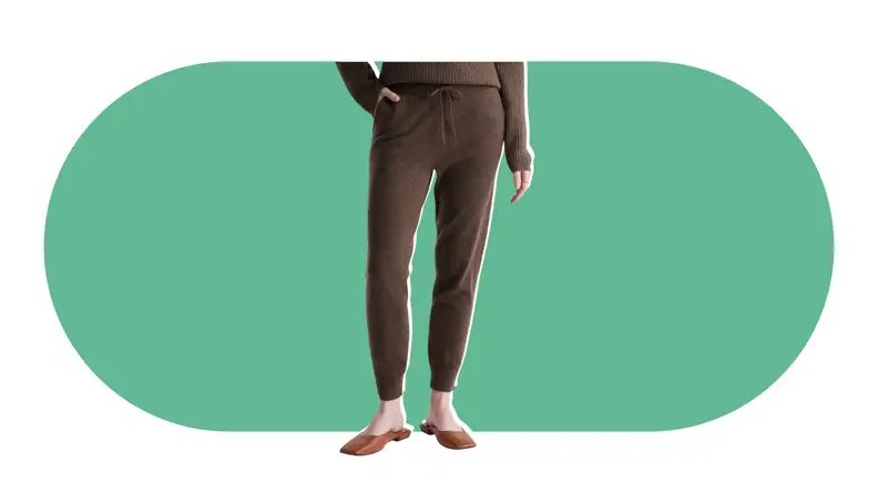 A model wearing brown cashmere sweatpants.
