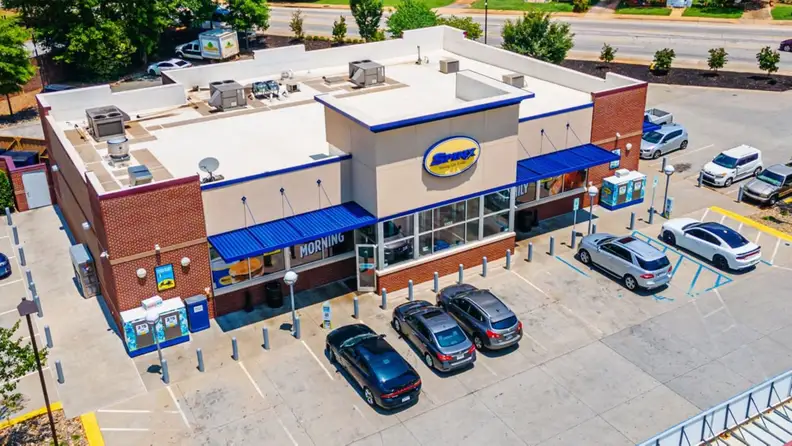 Aerial view of a Spinx store with a parking lot out front