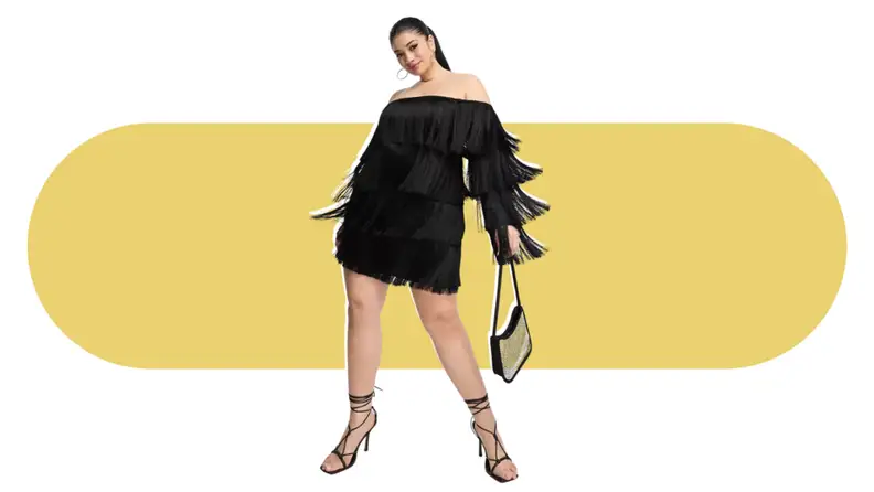 A model wearing a black fringe mini dress.