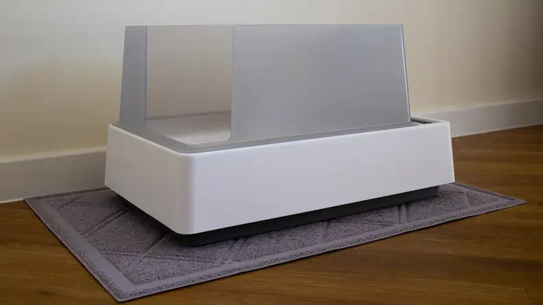 The Tuft and Paw Cove litter box against a white wall.