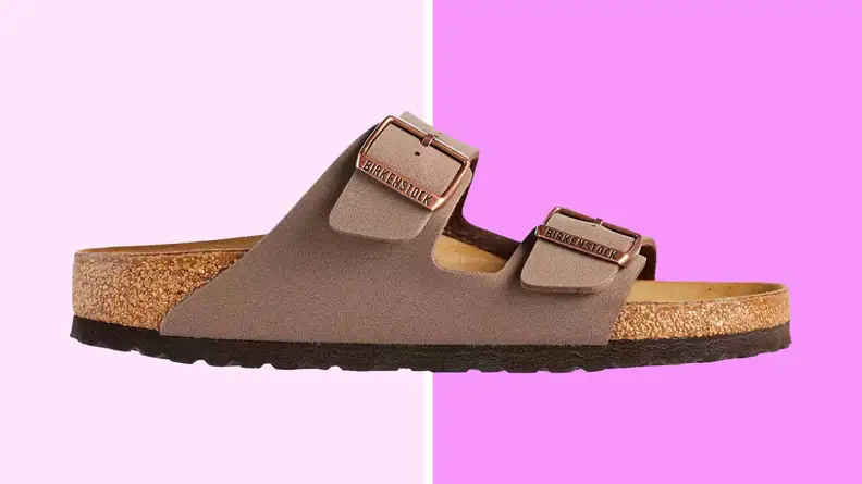 An image of a brown Arizona style Birkenstock slide sandal, with a cork footbed and two broad, over-the-foot straps.
