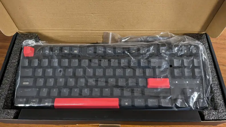 An overhead view of the Keychron C3 Pro while still in its plastic wrapping.