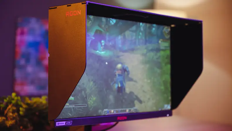 A gaming monitor with an anti-glare hood attached.