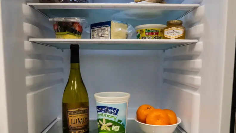 A shot of the interior of the fridge, focusing on the different ridges along which you can reposition the shelves.