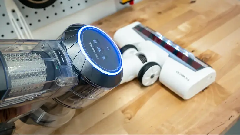 The Tineco Pure One S11 in handheld mode cleaning a workbench.