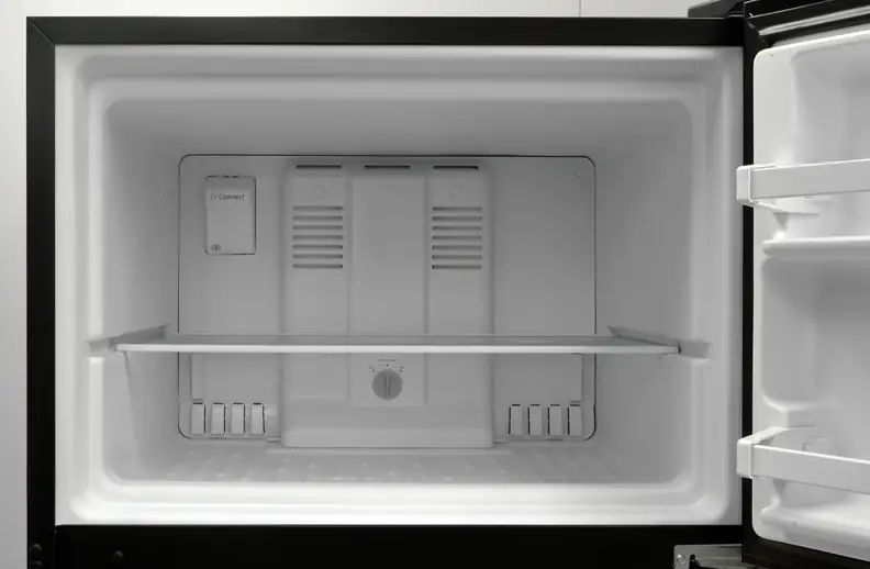 No light in the Whirlpool WRT318FZDB's freezer, but the glass shelf is a welcome addition. Pity you can't adjust its height...