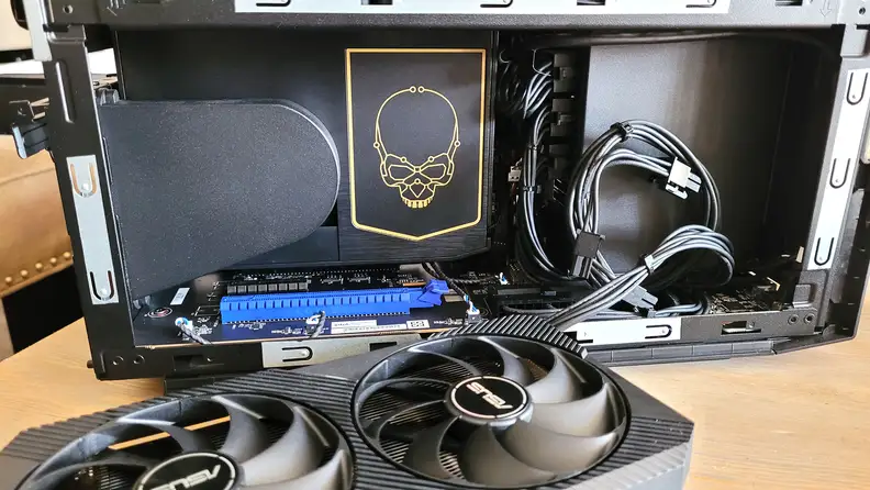 An open desktop PC case with components laying next to it