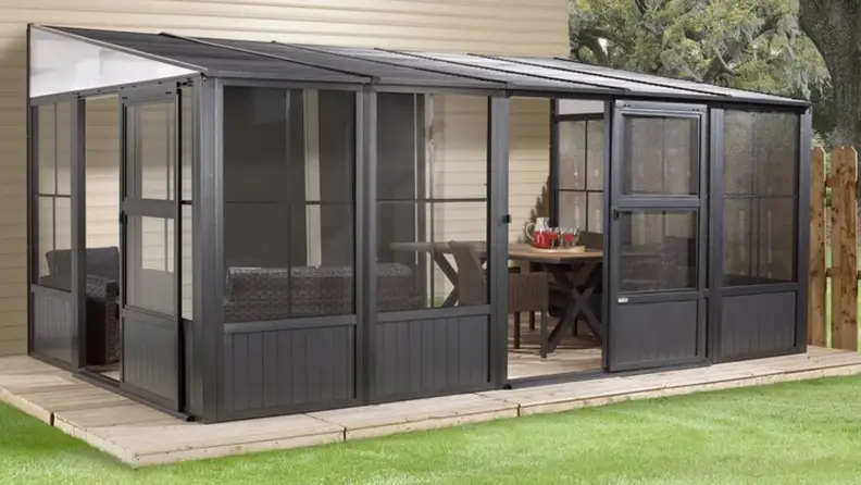 Metal patio enclosure in a backyard