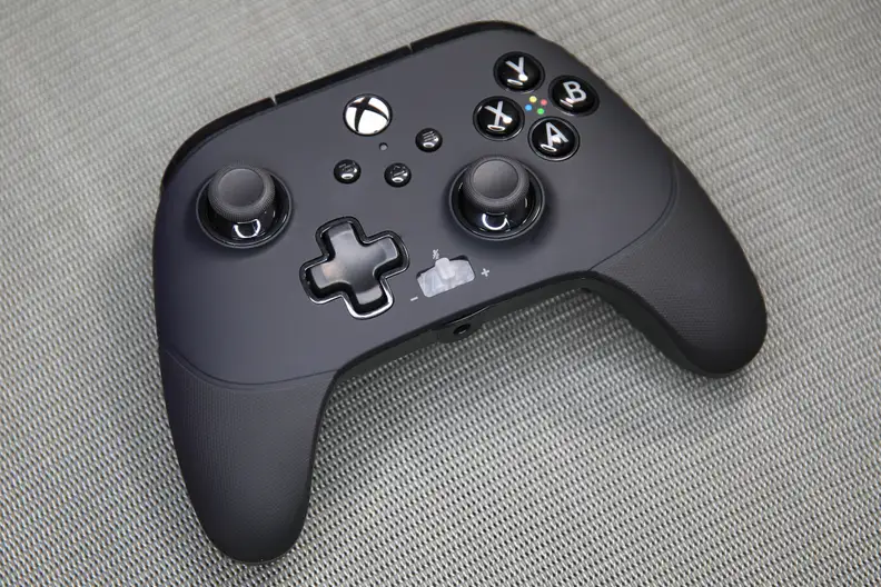 A black controller on a carpet