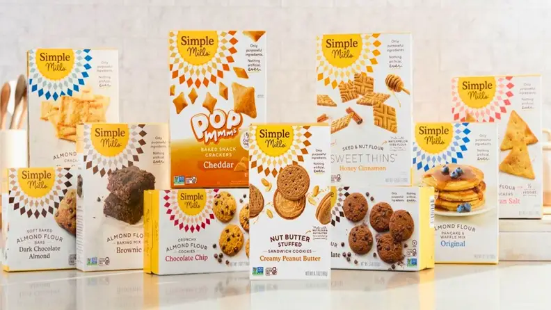 Simple Mills crackers, cookies, and baking mix boxes on a counter