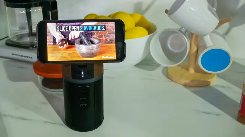 The M150 on a kitchen countertop with an iPhone attached to its lid.