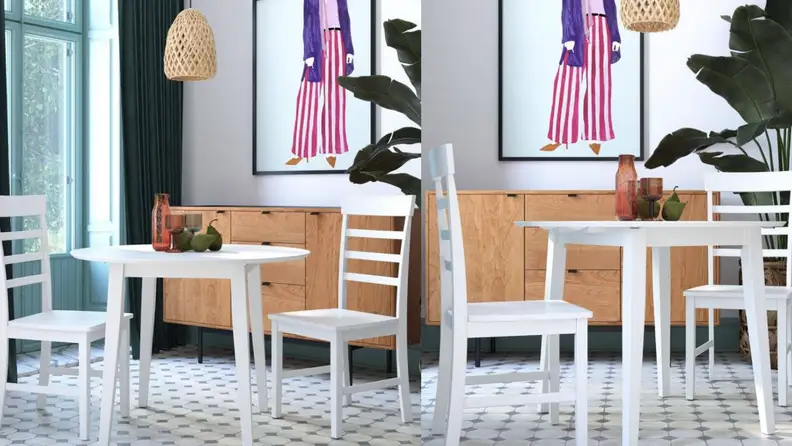 Small white table with two chairs in living room.