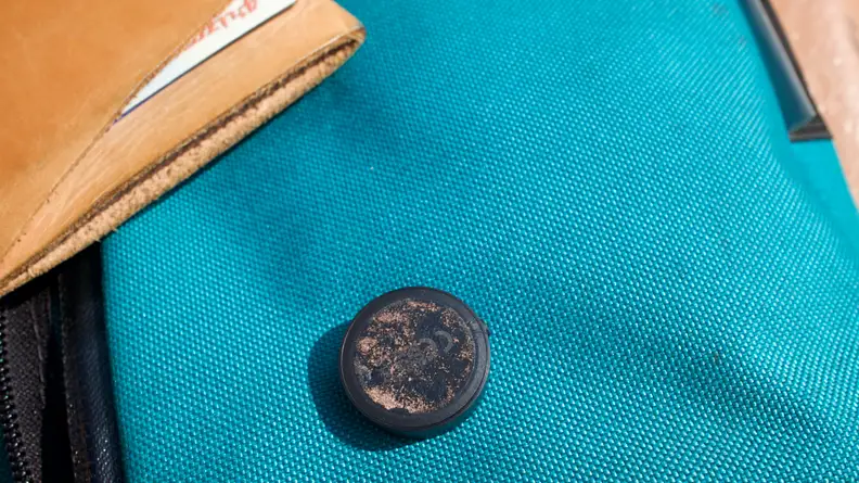 The underside of Tile's Sticker tracker, showing the worn adhesive.