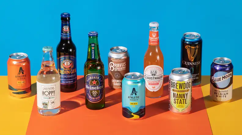 Several bottles and cans of nonalcoholic beer on a colorful background