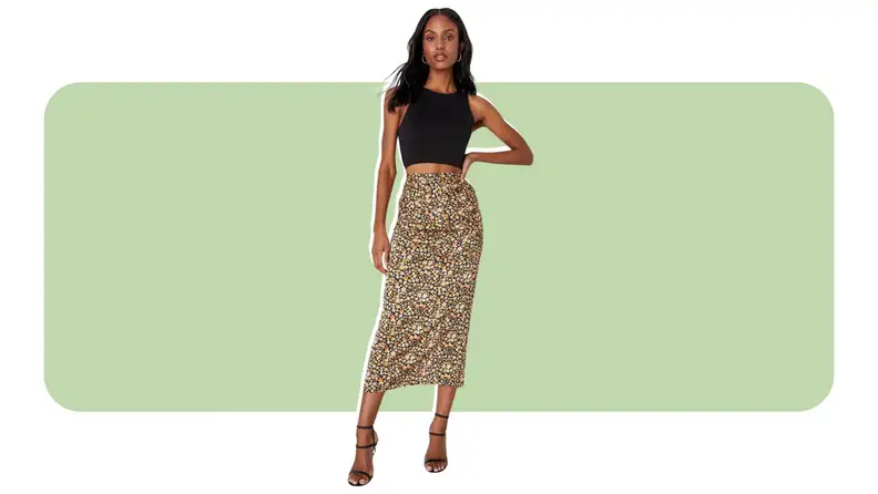 A model wearing a floral print midi skirt.