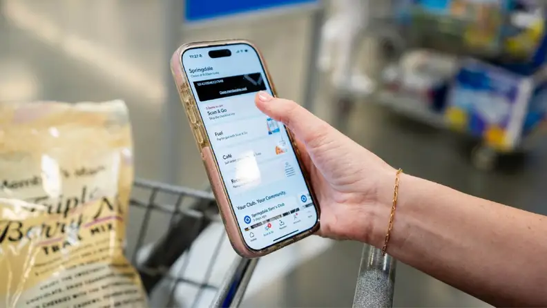 A shopper uses the Sam’s Club app’s Scan & Go feature on their phone while shopping in-store.