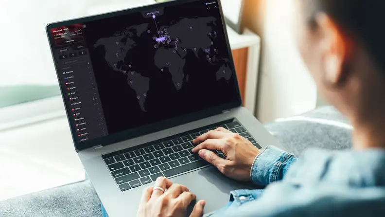 A person sits with a laptop