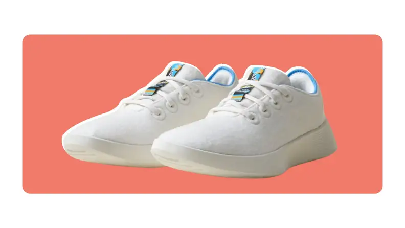 A pair of white Allbirds Women's Wool Runner 2 sneakers in Natural White/NZ Blue colors.