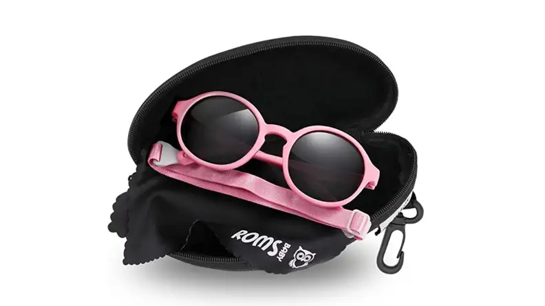 A pair of pink sunglasses on a black case.