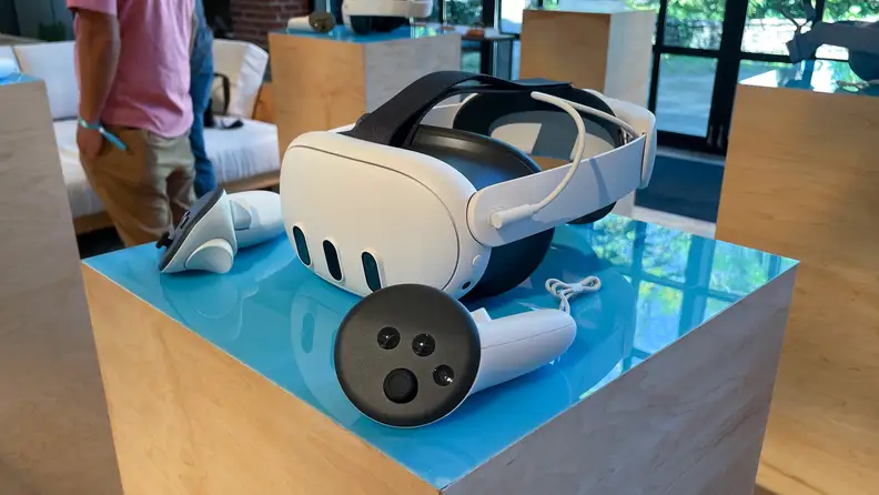A white Meta Quest 3, one of the best vr headsets, on a podium with two controllers