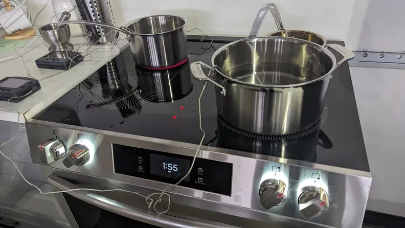 Two pots on top of the Frigidaire Gallery stove, being tested.