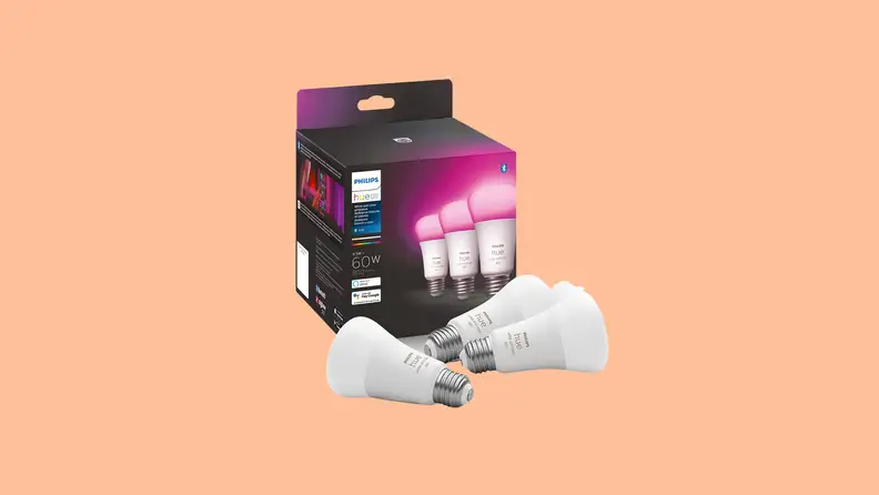 A box of Philips Hue lightbulbs against a peach color background.