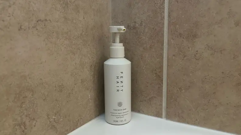 Photo of the Fenty Hair The Rich One Moisture Repair Shampoo in a shower.