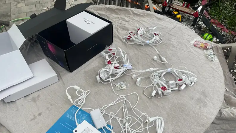 The contents of the Govee Permanent Outdoor Lights packaging atop a table.
