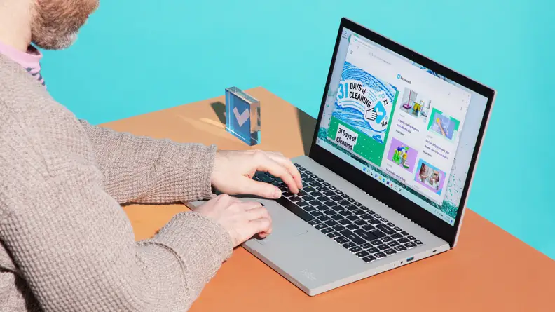 A person typing on the Acer Aspire Vero laptop.