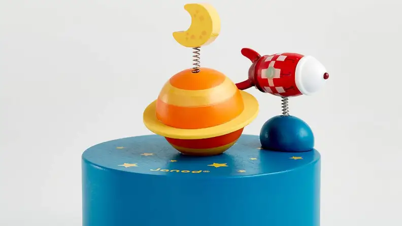 Wooden toy that is a planet and a spaceship