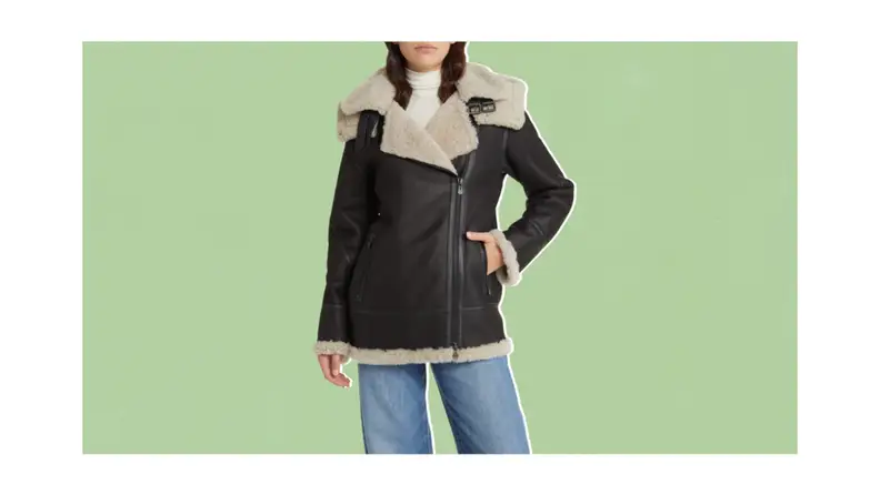 A model wearing a brown shearling coat.