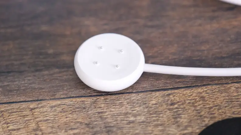 The Pixel Watch 2 sharger, with its pogo pins on display.