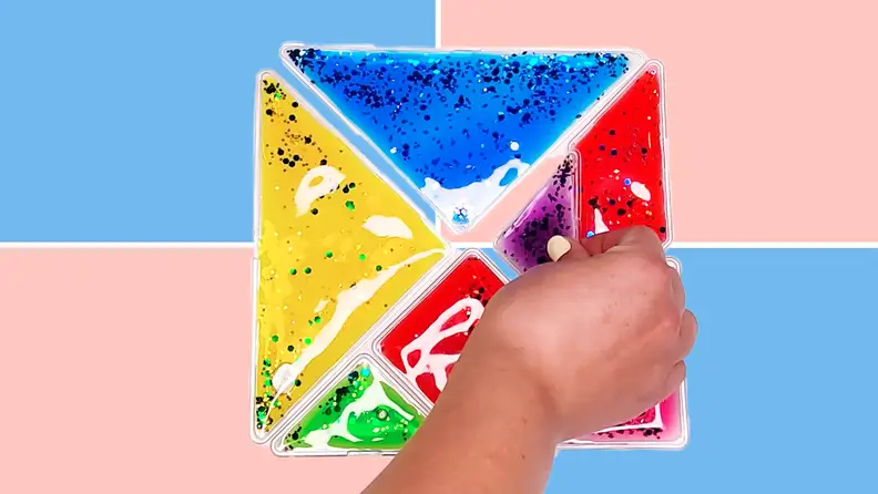 Person using hand to construct Fun and Function Busy Fingers Tangram Gel Puzzle.