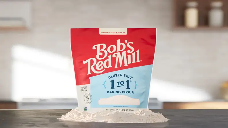 Bag of Bob's Red Mill gluten-free 1 to 1 baking flour with spilled flour