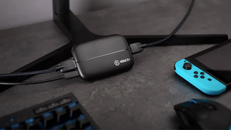 An image of an Elgato capture card plugged into a monitor and laptop, sitting next to a Nintendo Switch.